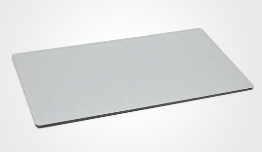 A minimalist, rectangular light gray desk mat with rounded corners, shown at an angle on a clean white background.