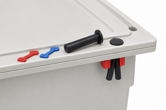 Close-up of a light gray plastic storage bin showing the lid edge with a black handle, a red and blue latch key, and red and black latch release pieces on a white background.