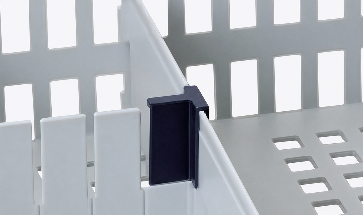 A close-up of a dark navy blue plastic clip or bracket attached to the edge of a white slatted plastic basket or tray.