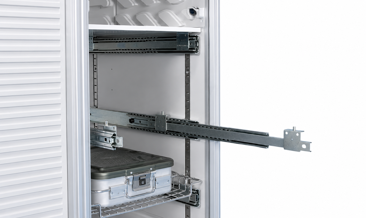 A close-up of a storage cabinet interior with sliding drawer tracks, a wire shelf, and a hard case installed inside, shown against a white background.