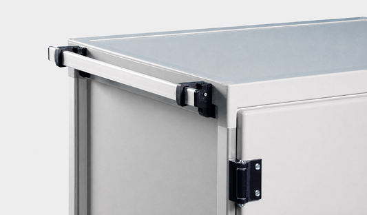 Close-up of a light gray metal utility cabinet or storage unit showing the top edge, hinge, and latch hardware against a plain light background.