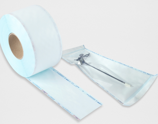 Roll of sterilization media with a small tool on a white background