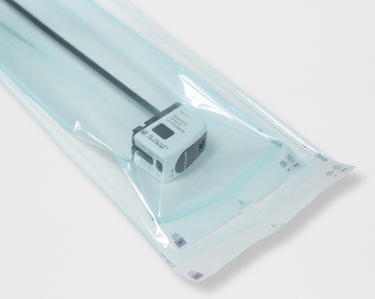 Small electronic device in clear packaging on a light gray background