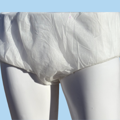White shorts on a mannequin against a blue background