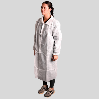 Person wearing a white lab coat on a gray background