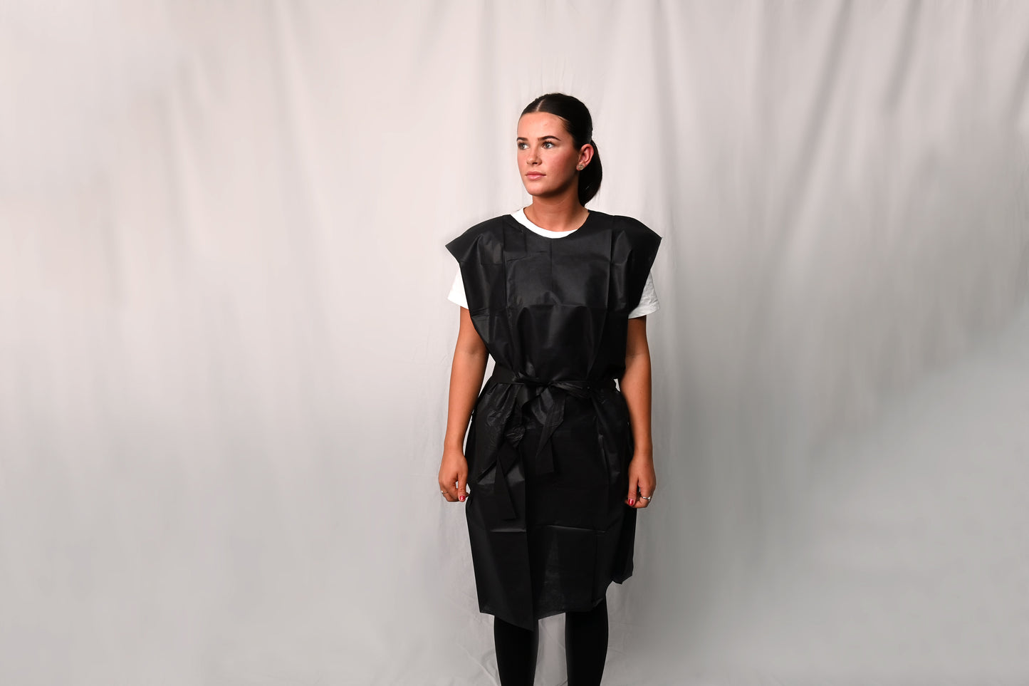 Person wearing a dark X-Ray Gown over a white shirt against a plain background