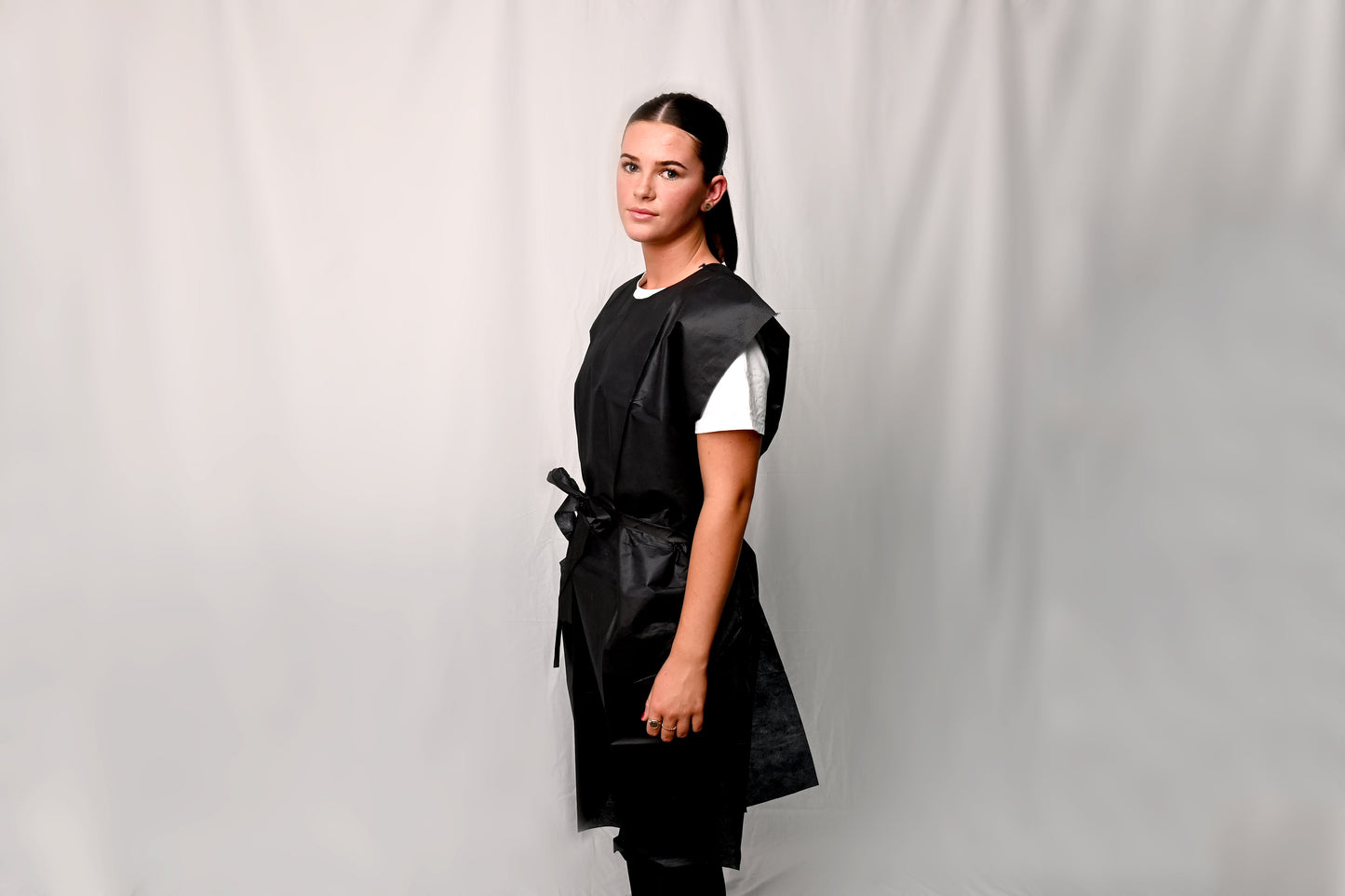 Person wearing an X-Ray Gown over a white shirt against a plain background