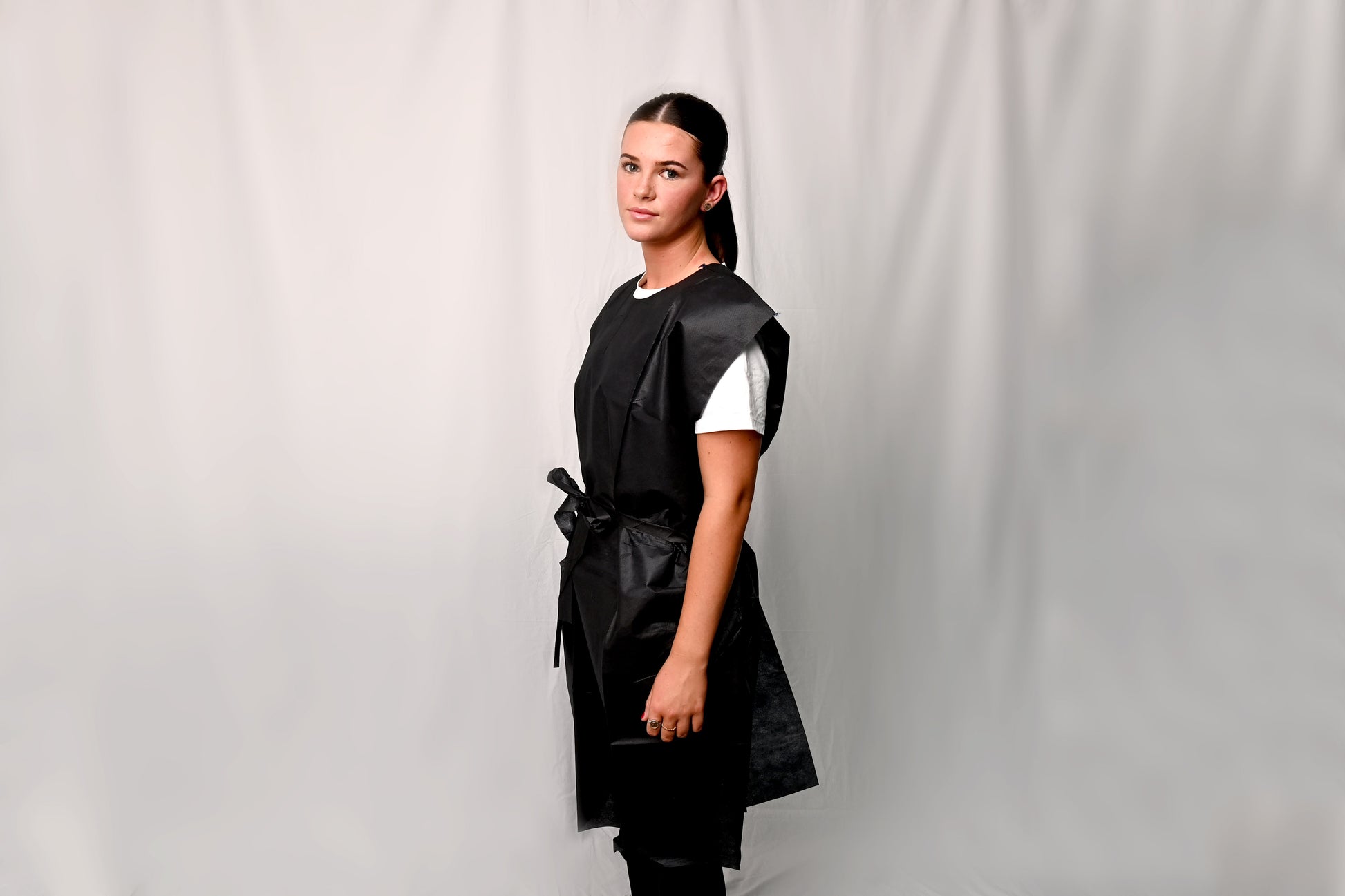 Person wearing an X-Ray Gown over a white shirt against a plain background